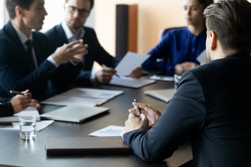 Corporate meeting in formal environment.